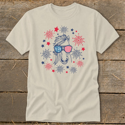 Horse wearing American flag sunglasses surrounded by red, white, and blue fireworks and stars.