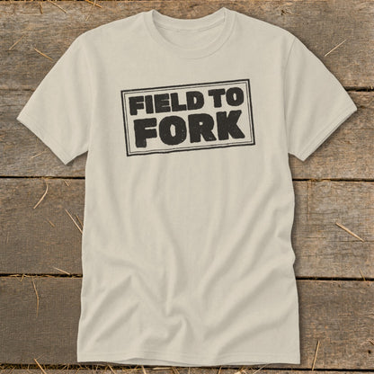 A cream-colored short-sleeved t-shirt with the words "FIELD TO FORK" printed in black on the chest.