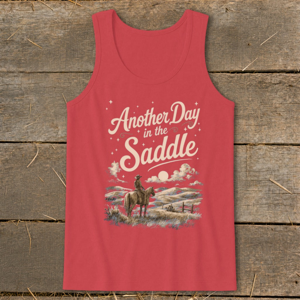 Coral tank top with "Another Day in the Saddle" text and cowboy on horseback graphic.