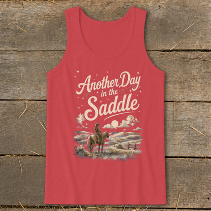 Coral tank top with "Another Day in the Saddle" text and cowboy on horseback graphic.