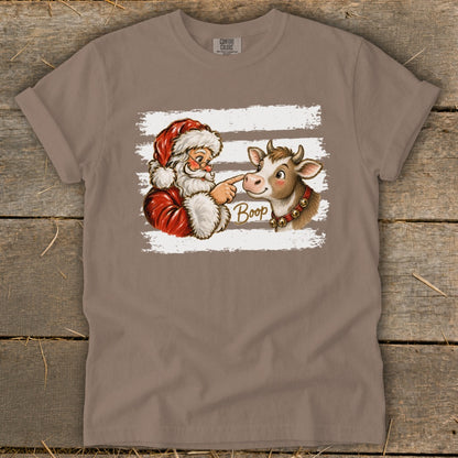 Santa booping a cow, with the word "Boop" written in script.