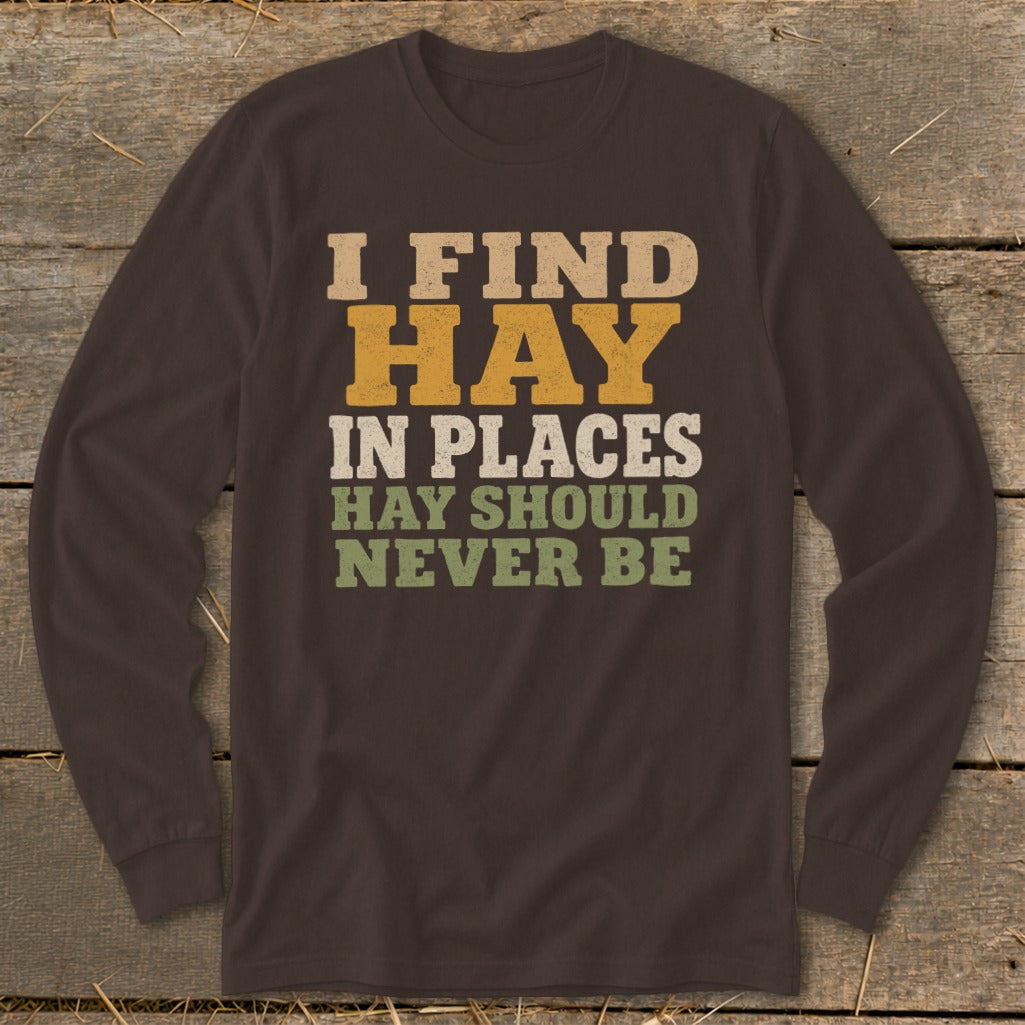 Brown long-sleeve shirt with text "I FIND HAY IN PLACES HAY SHOULD NEVER BE".