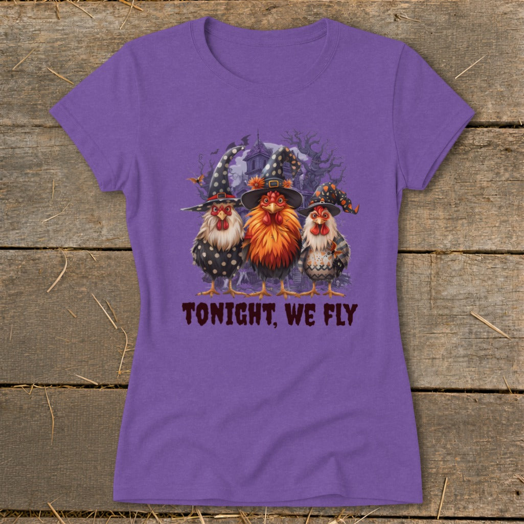 Three chickens in witch hats stand before a spooky house, with text "TONIGHT, WE FLY".
