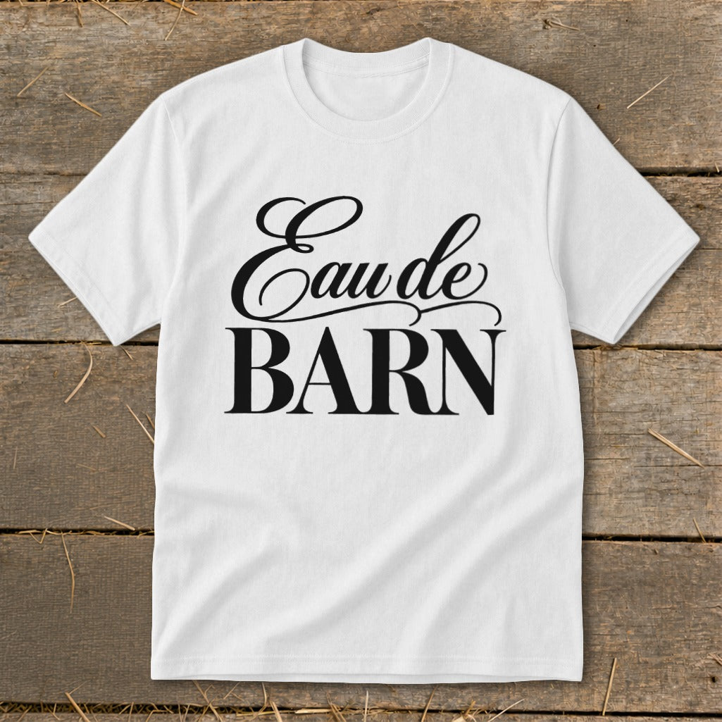 White t-shirt with black text "Eau de BARN" in script and block fonts.