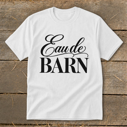 White t-shirt with black text "Eau de BARN" in script and block fonts.