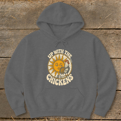A dark gray hooded sweatshirt featuring a retro graphic of a sun, a rooster, and the text Up With The Chickens.