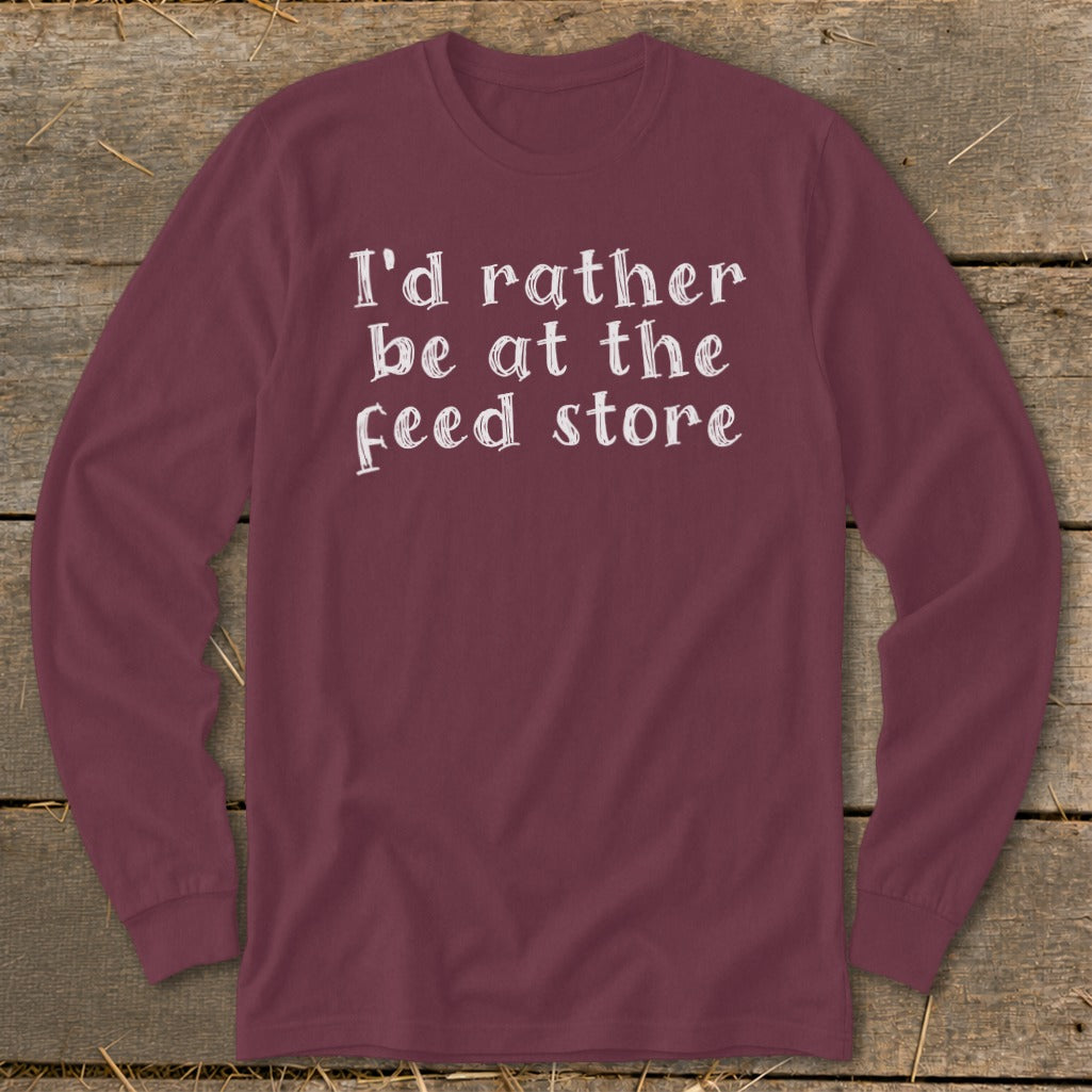 Maroon long sleeve shirt with white text "I'd rather be at the feed store".