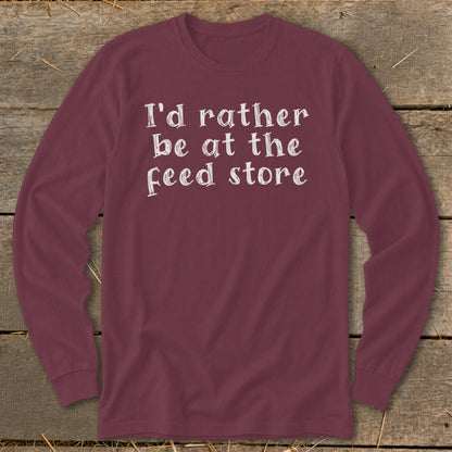 Maroon long sleeve shirt with white text "I'd rather be at the feed store".