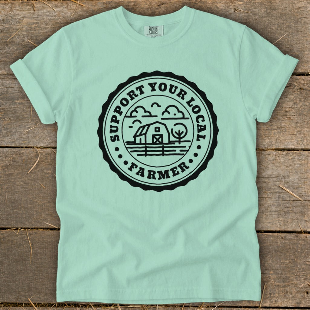 Mint t-shirt with black circular graphic reading "Support Your Local Farmer" and farm scene.