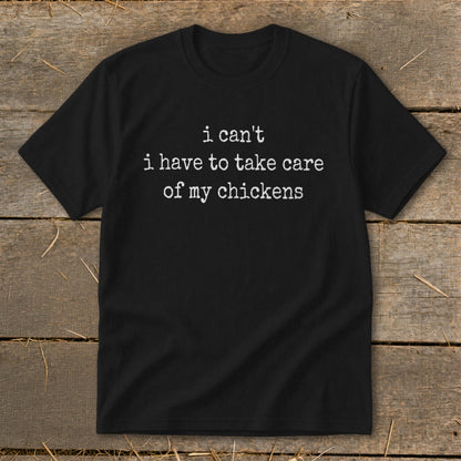 Black t-shirt with white text that reads "i can't i have to take care of my chickens".