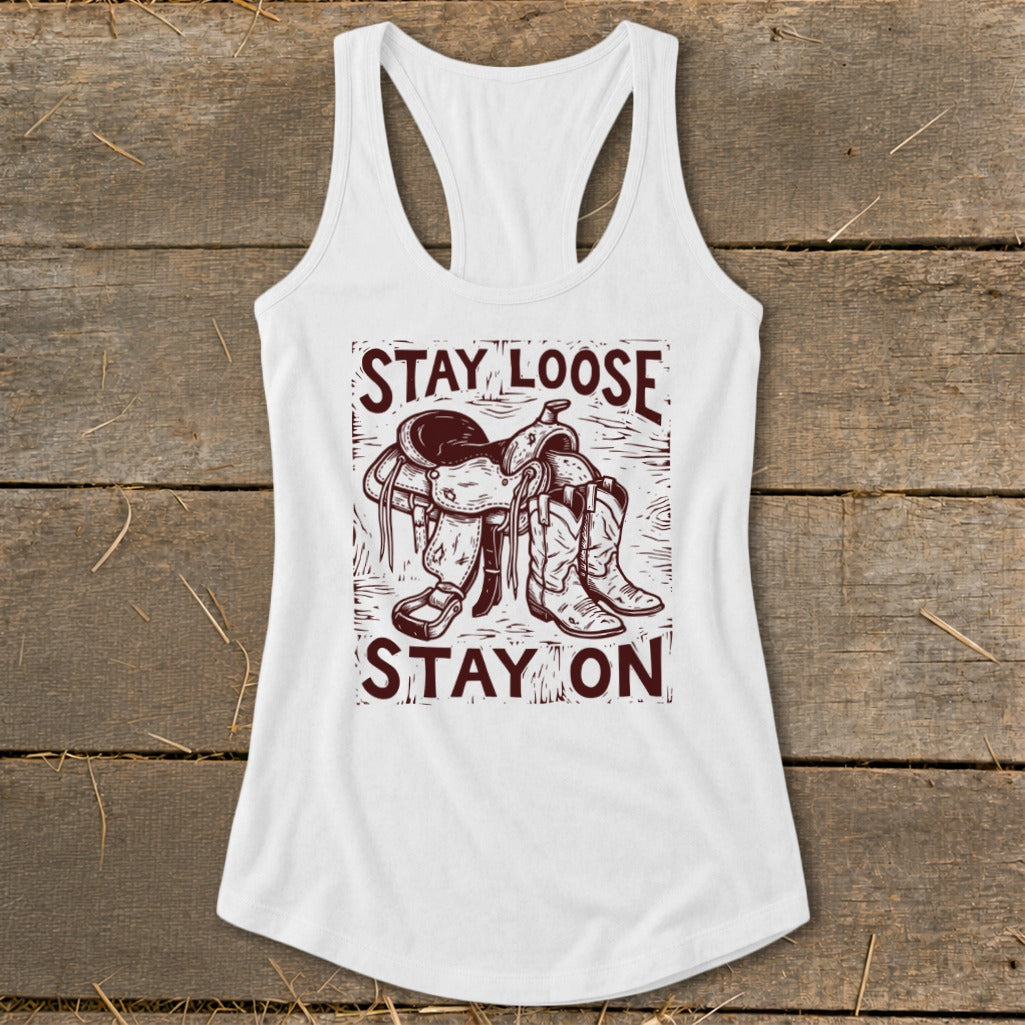 White tank top with "Stay Loose Stay On" text and a saddle and boots graphic.