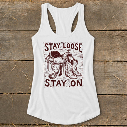White tank top with "Stay Loose Stay On" text and a saddle and boots graphic.