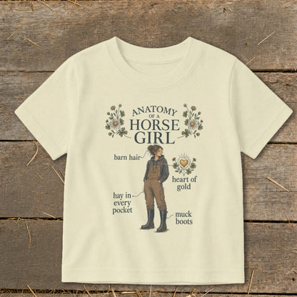 Cream t-shirt with "Anatomy of a Horse Girl" graphic, featuring a girl with labels.