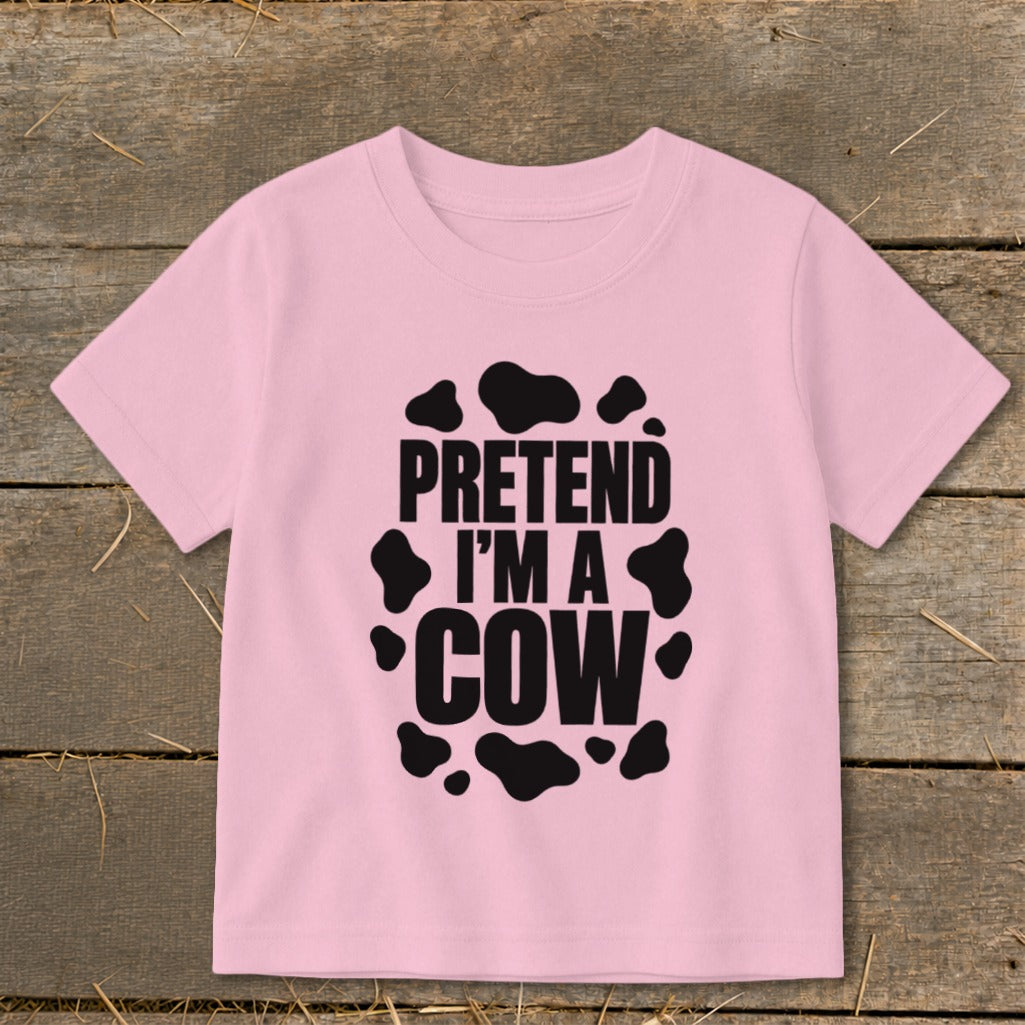 Pink t-shirt with black cow spots and text "PRETEND I'M A COW".