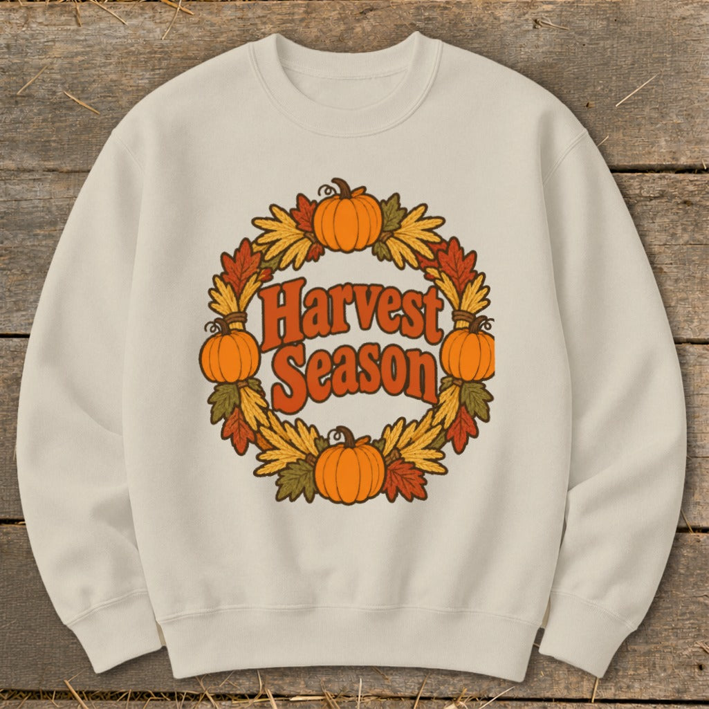Light cream sweatshirt with a retro "Harvest Season" graphic featuring pumpkins and autumn leaves.