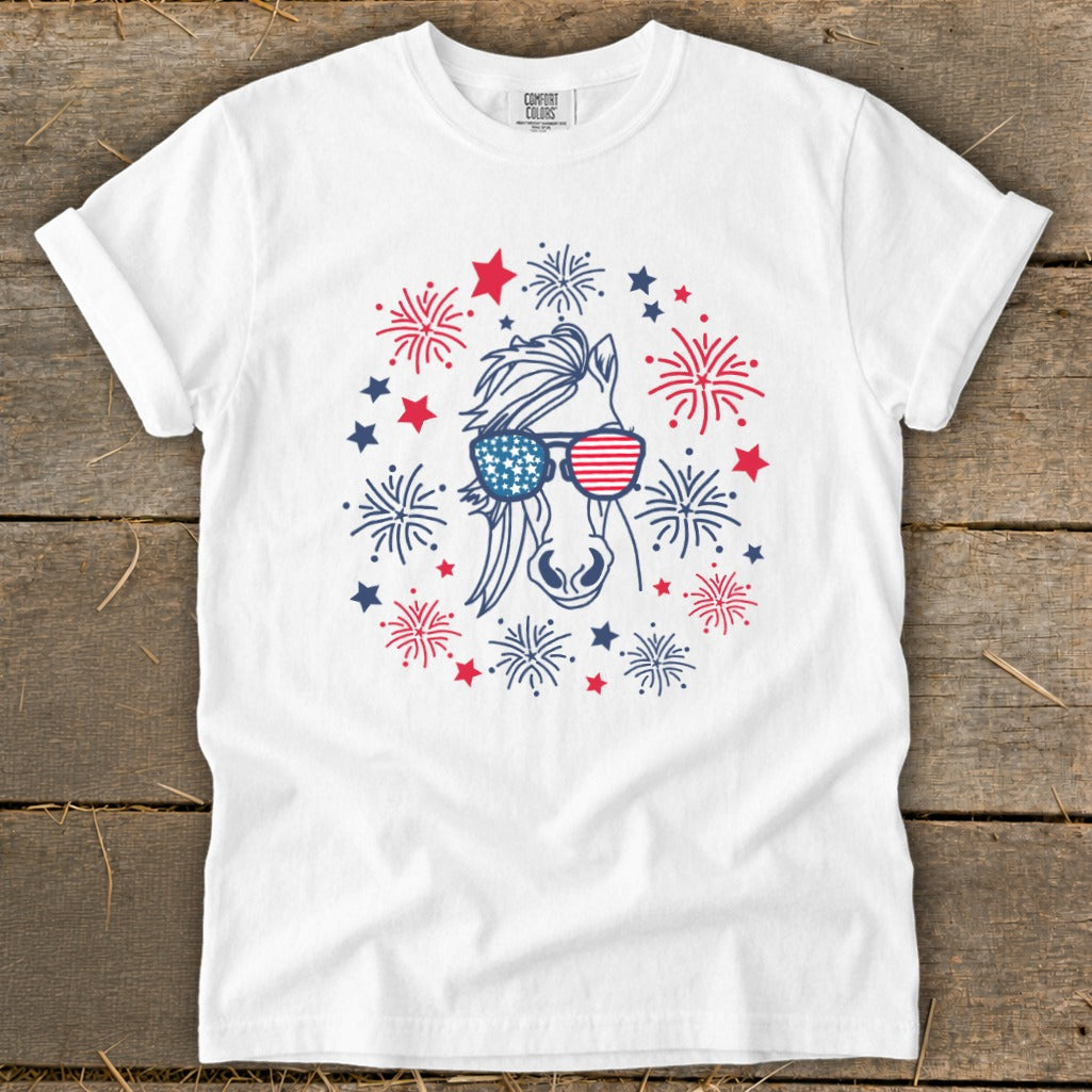 White t-shirt with a horse wearing American flag sunglasses, surrounded by fireworks.