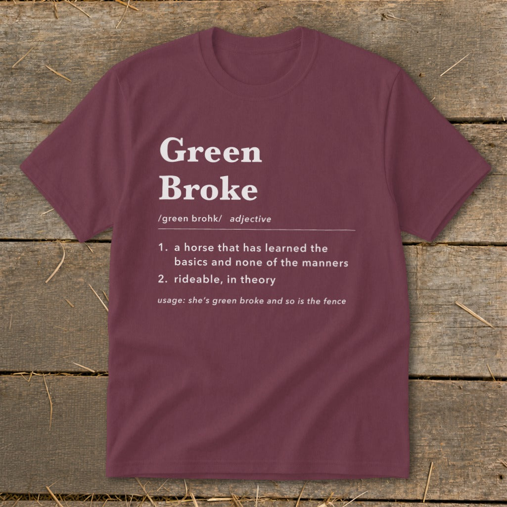 A maroon t-shirt with a humorous dictionary definition of Green Broke printed in white text on the front.