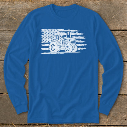 White tractor graphic on distressed American flag background on blue long-sleeve shirt.