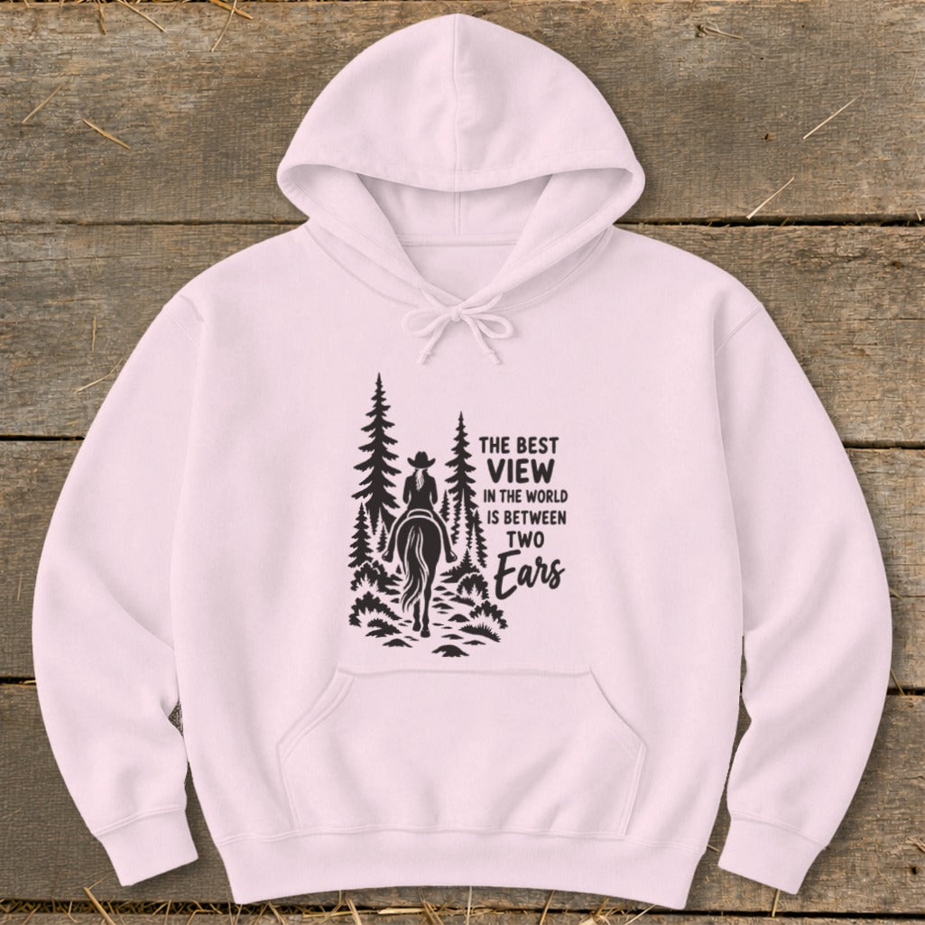 Light pink hooded sweatshirt with a black graphic of a horseback rider and text reading The Best View in the World Is Between Two Ears.