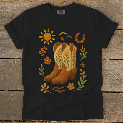 Black t-shirt with cowboy boots, sun, horseshoe, and floral design.