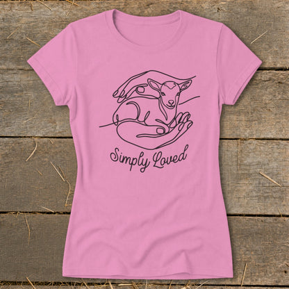 Pink t-shirt with line art of hands holding a lamb and the text "Simply Loved".