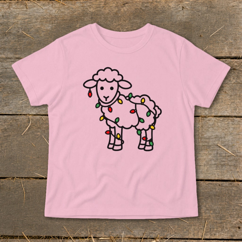 Light pink children's t-shirt featuring a cartoon sheep tangled in colorful Christmas lights.