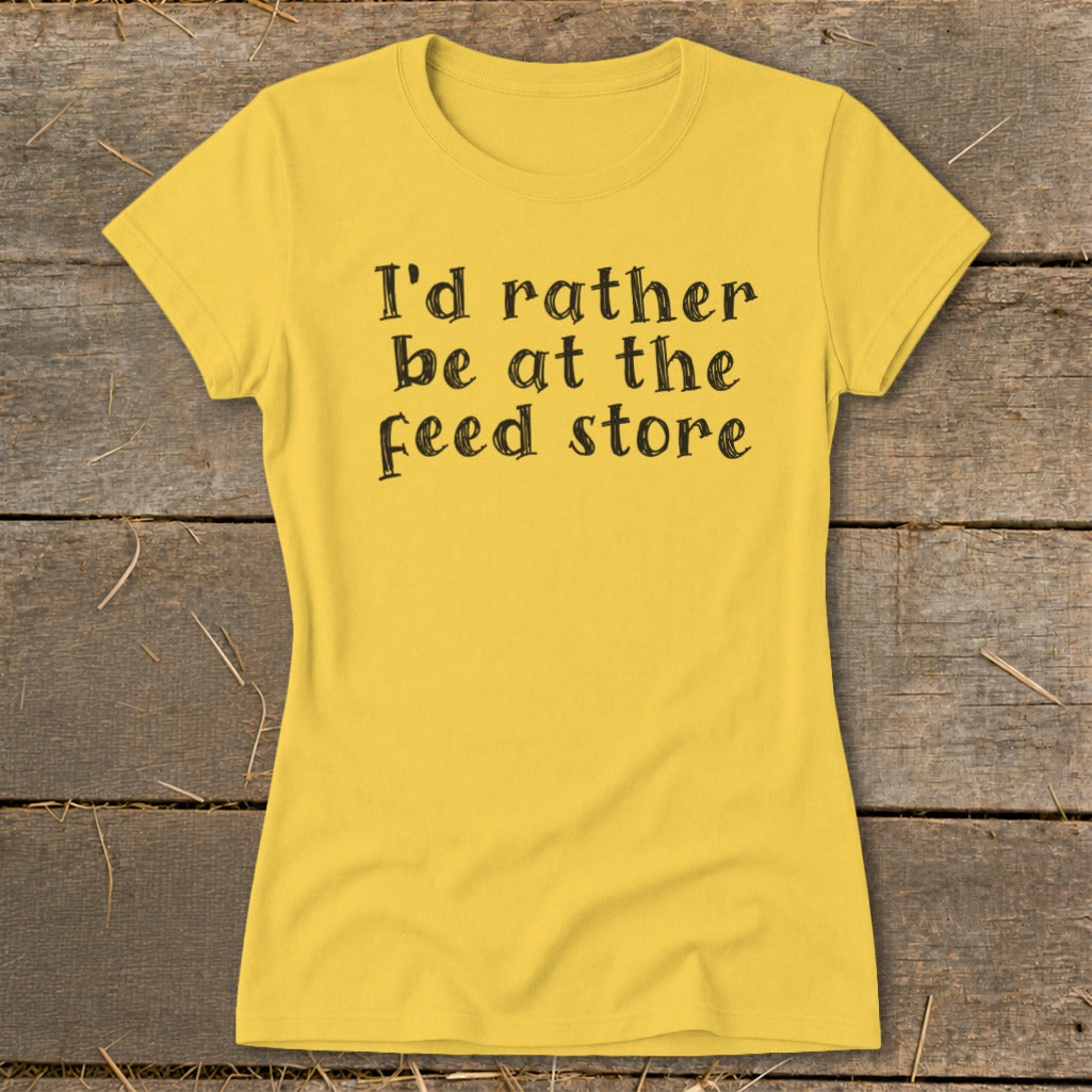 Yellow t-shirt with black text that reads "I'd rather be at the feed store."