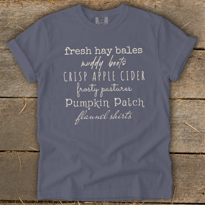 Slate blue Comfort Colors t-shirt with "fresh hay bales muddy boots" text.