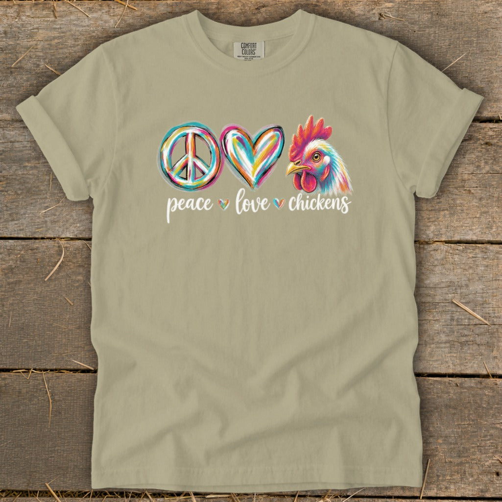 Tan t-shirt with peace sign, heart, and chicken graphic and "peace love chickens" text.