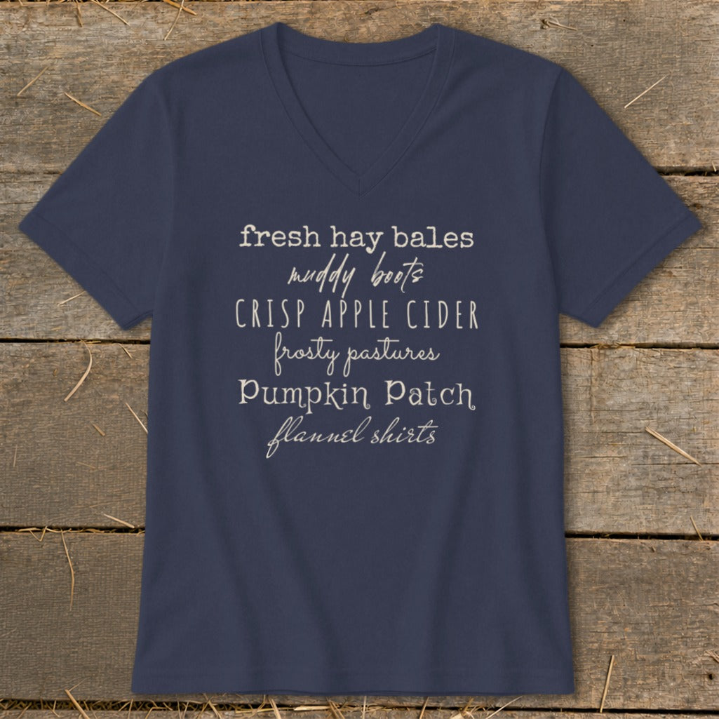 Navy v-neck t-shirt with text "fresh hay bales, muddy boots, crisp apple cider, frosty pastures, pumpkin patch, flannel shirts".