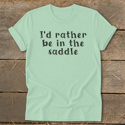 Light mint t-shirt with black text reading "I'd rather be in the saddle."