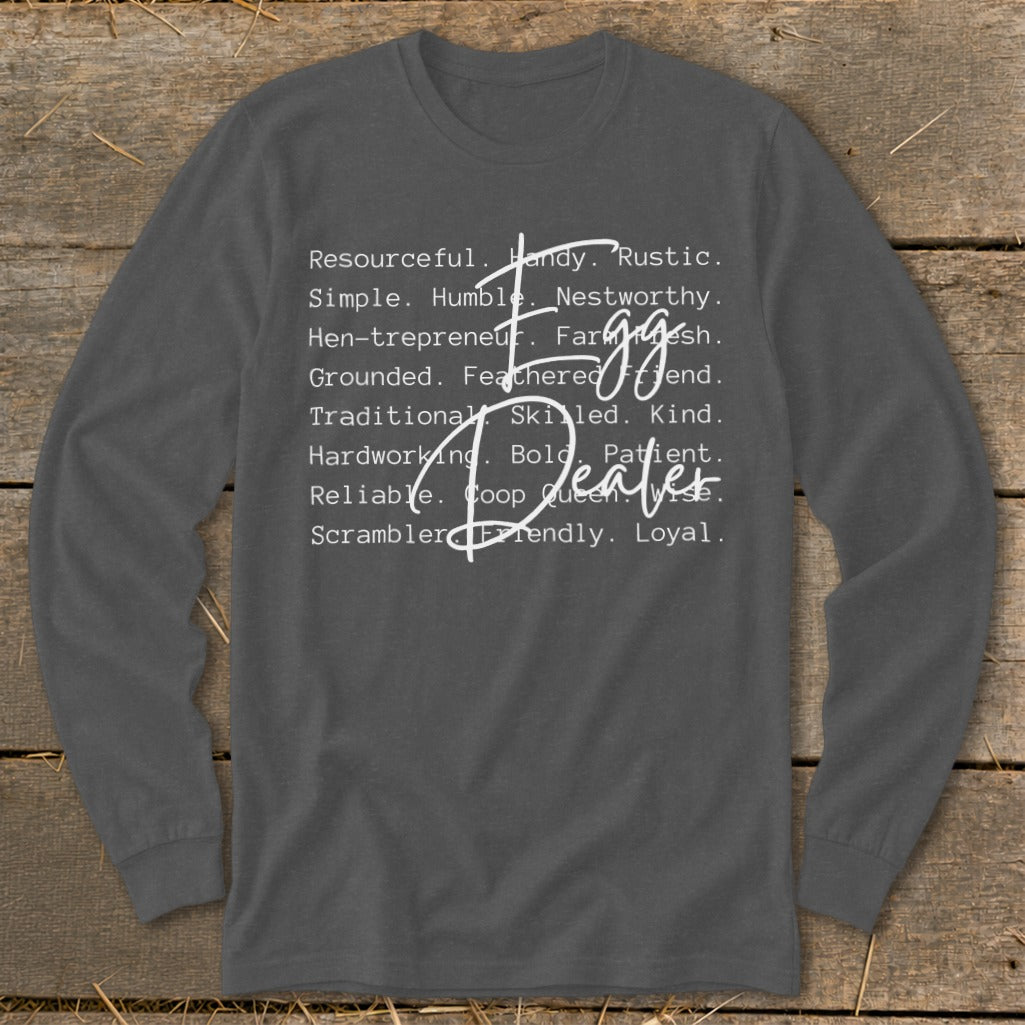Dark grey long sleeve shirt with white text listing attributes and "Egg Dealer" in script.