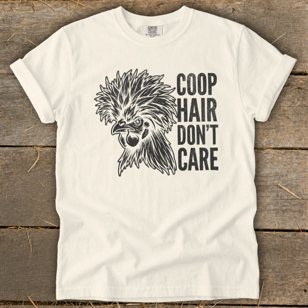White t-shirt with black graphic of a fancy chicken and text "Coop Hair Don't Care".