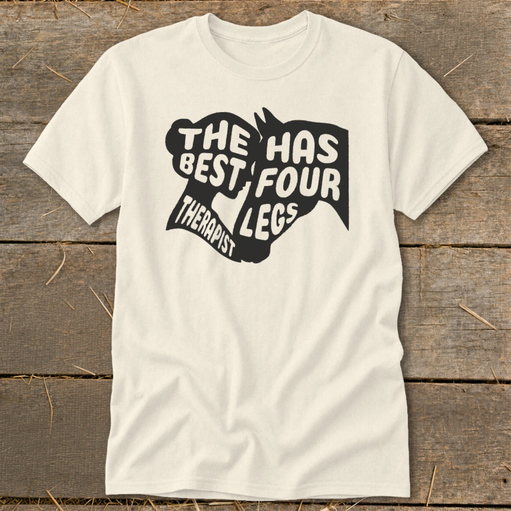 Cream t-shirt with black graphic text reading "THE BEST THERAPIST HAS FOUR LEGS".