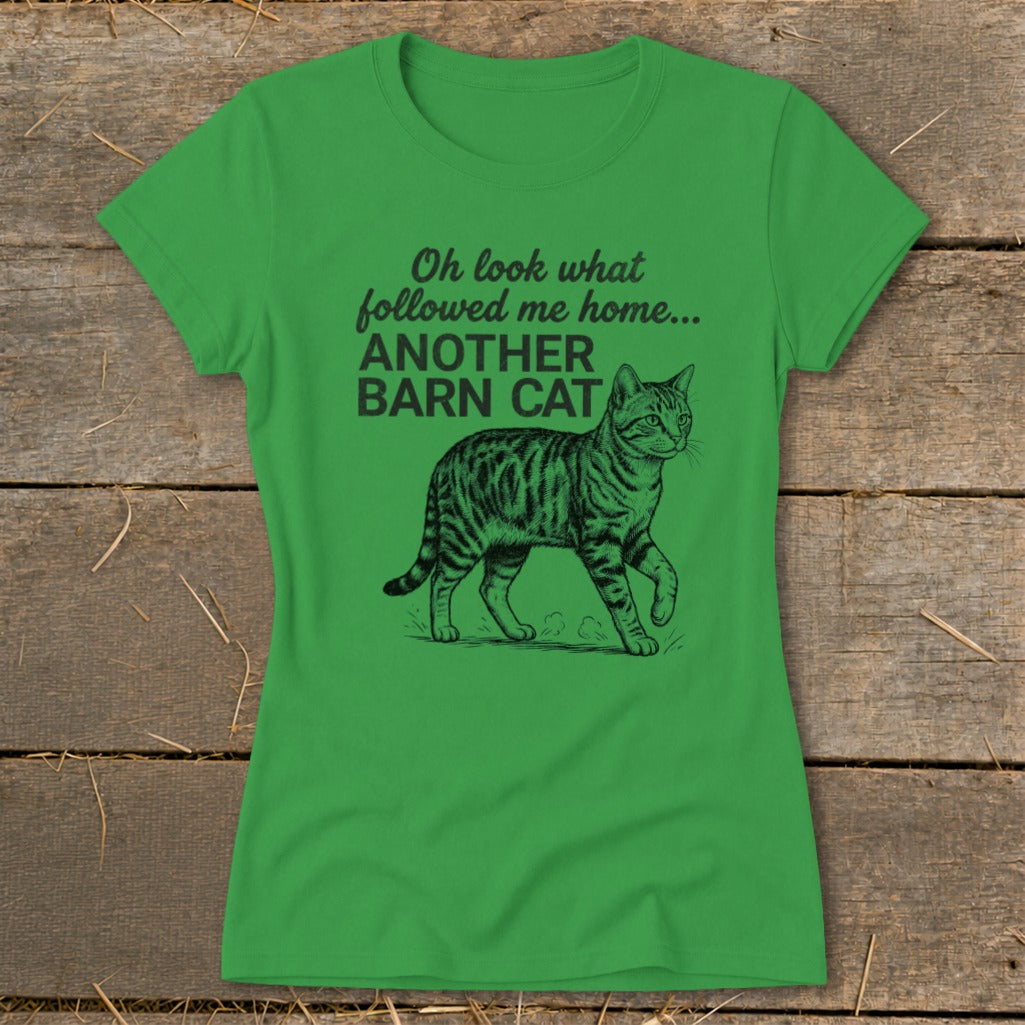 Green t-shirt with black text "Oh look what followed me home... ANOTHER BARN CAT" and cat illustration.