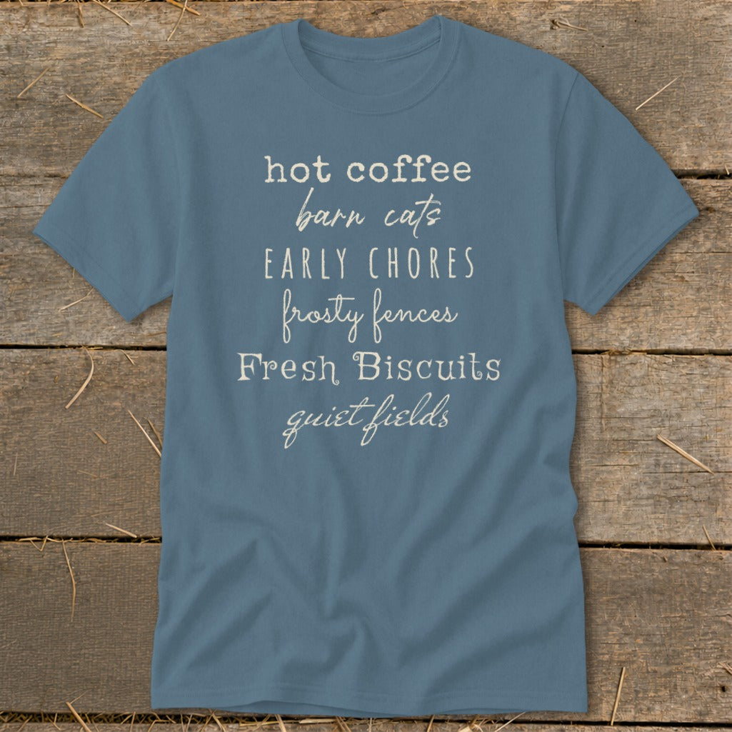 Blue t-shirt with text listing "hot coffee," "barn cats," "early chores," "frosty fences," "Fresh Biscuits," and "quiet fields."