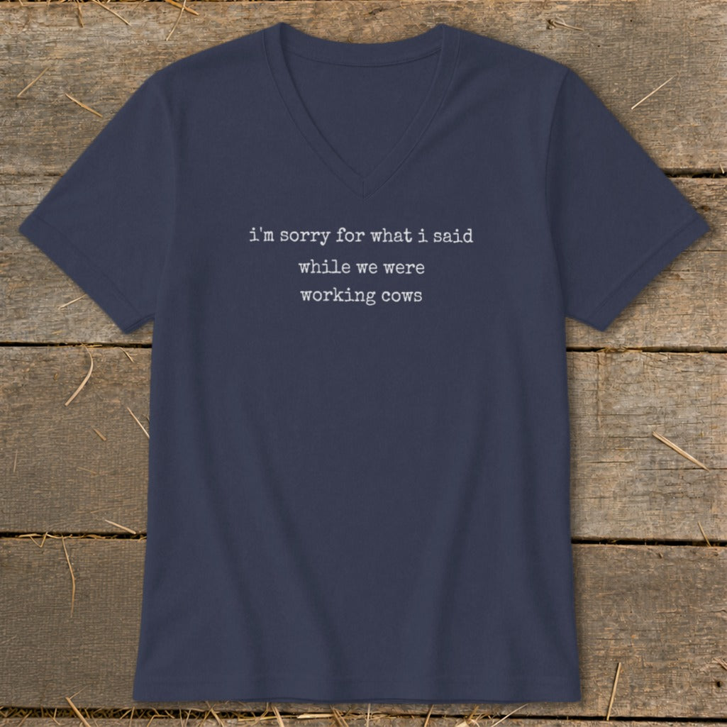 Navy v-neck t-shirt with white text that reads "i'm sorry for what i said while we were working cows".