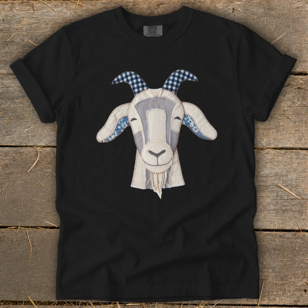 Black t-shirt with a stitched goat face graphic in white and blue patterns.