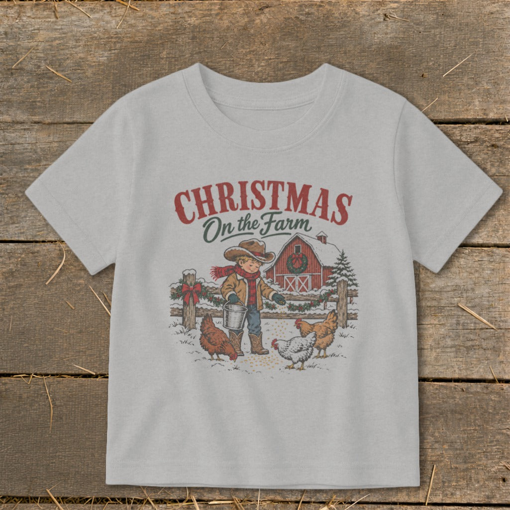 T-shirt with "Christmas On the Farm" text, a boy feeding chickens near a barn.
