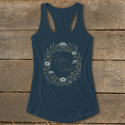 Dark blue tank top with a floral wreath graphic that says "Pasture Raised".