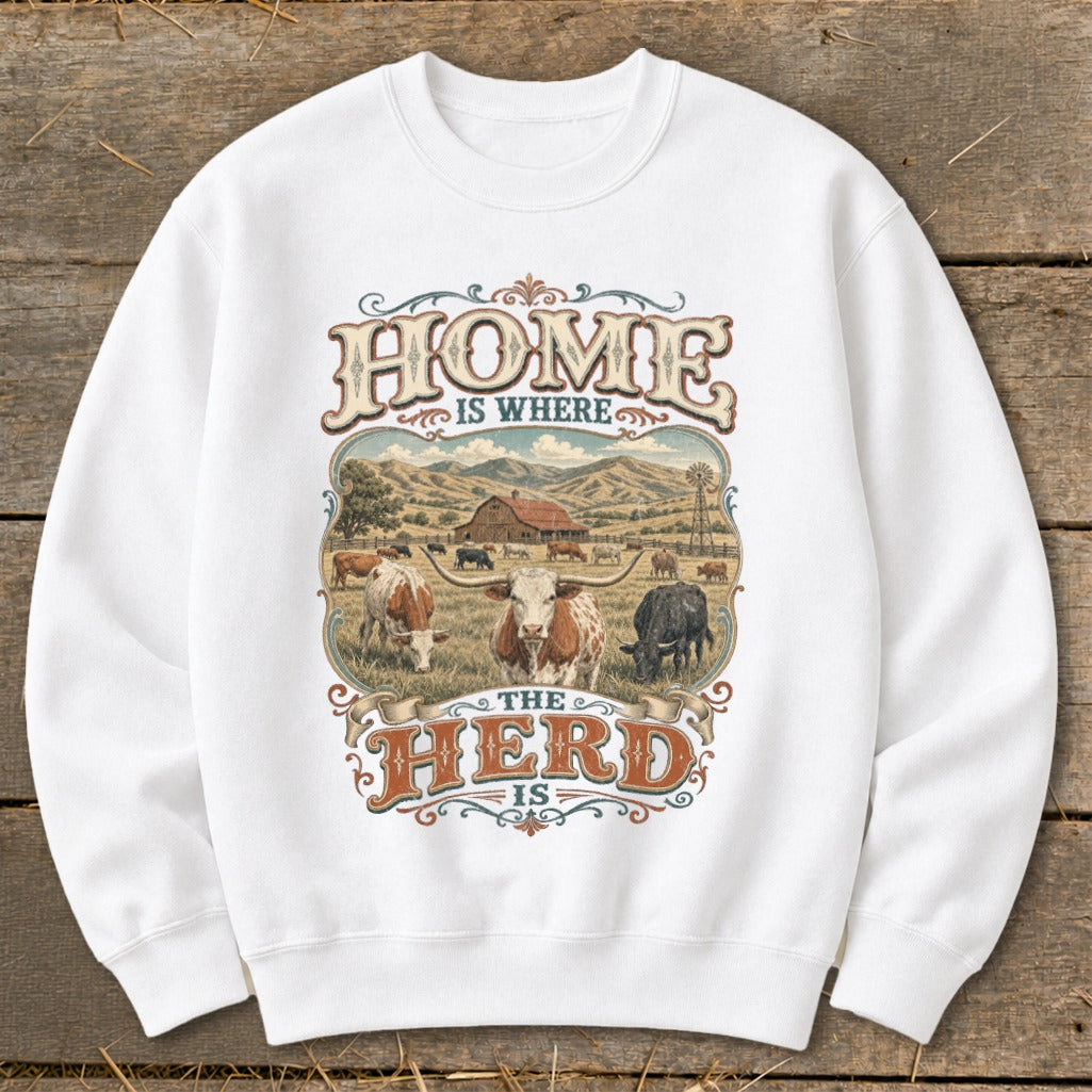 White sweatshirt with "HOME IS WHERE THE HERD IS" text and cattle farm scene.
