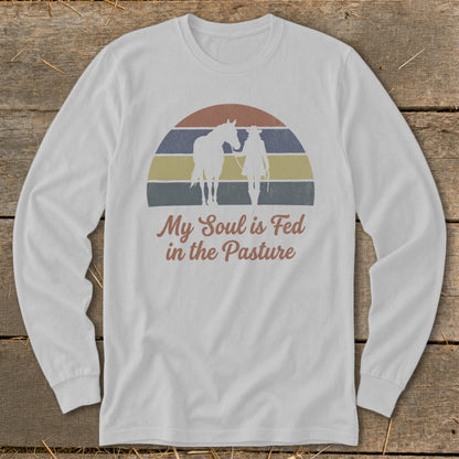 White long-sleeve shirt with vintage graphic of horse, cowboy, and text.