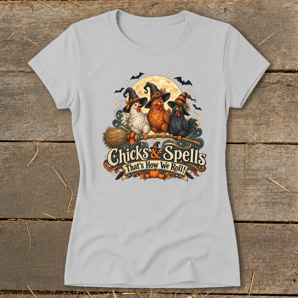Three Halloween chickens in witch hats sit on a broom with "Chicks & Spells" text.