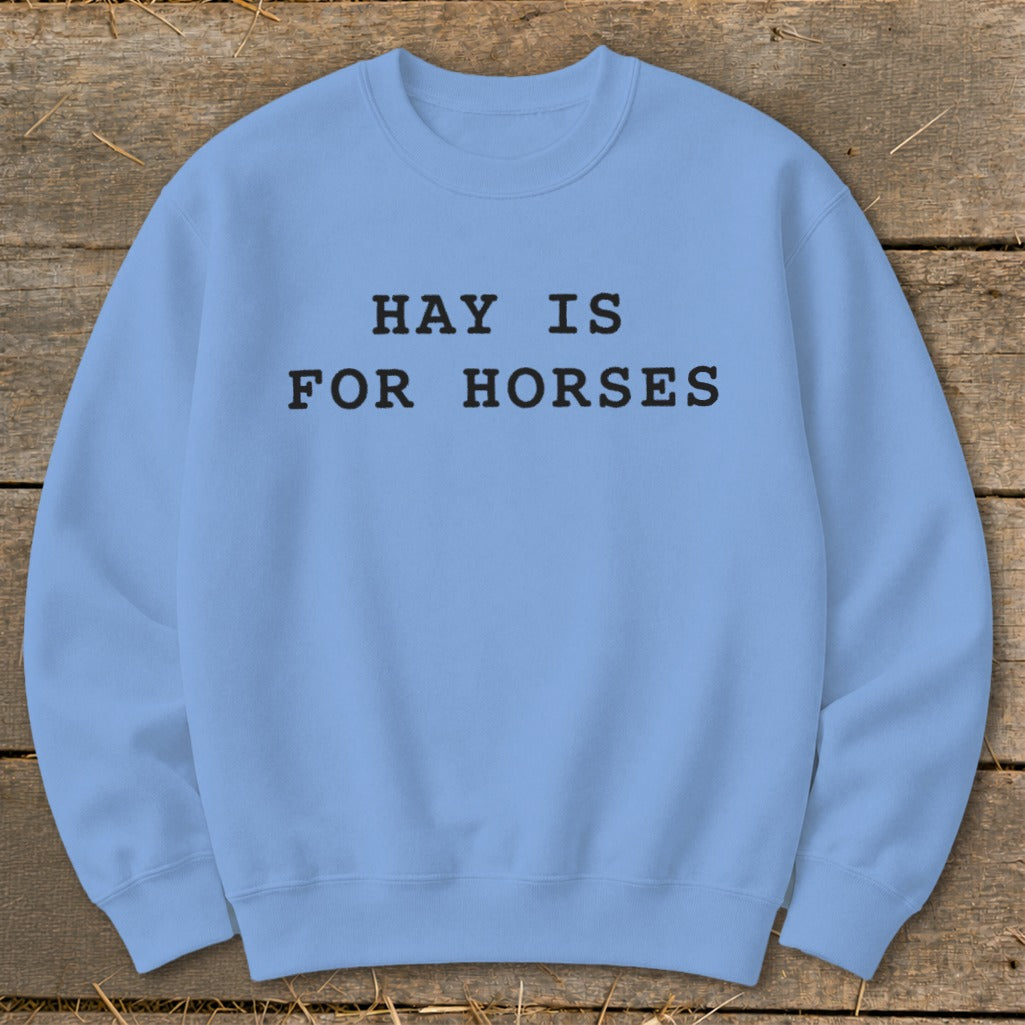 Light blue crewneck sweatshirt with black text that reads "HAY IS FOR HORSES".
