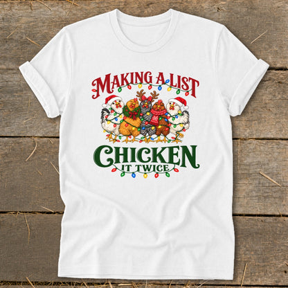 White t-shirt with chickens wearing Santa hats and Christmas lights, reads "Making a list and chicken it twice."