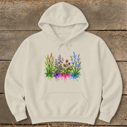 A cream-colored hoodie featuring a watercolor graphic of wildflowers and grasses across the chest.