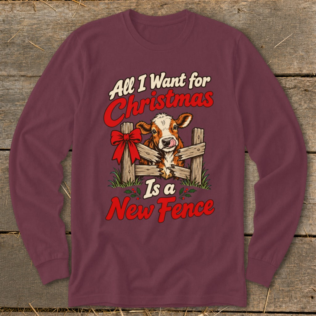 Maroon long sleeve shirt with a cow behind a broken fence and text "All I Want for Christmas Is a New Fence."