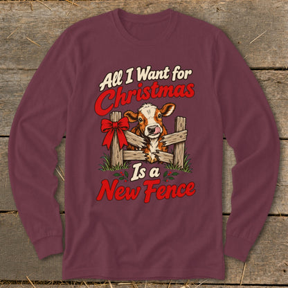 Maroon long sleeve shirt with a cow behind a broken fence and text "All I Want for Christmas Is a New Fence."