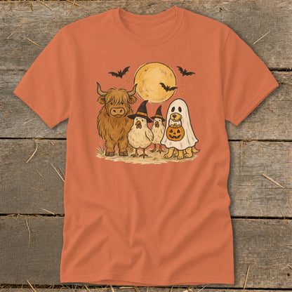 Highland cow, chickens, and dog dressed for Halloween under a full moon.
