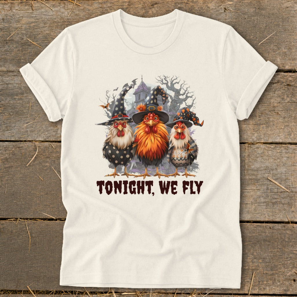 Three chickens in witch hats stand before a spooky house with text "TONIGHT, WE FLY."